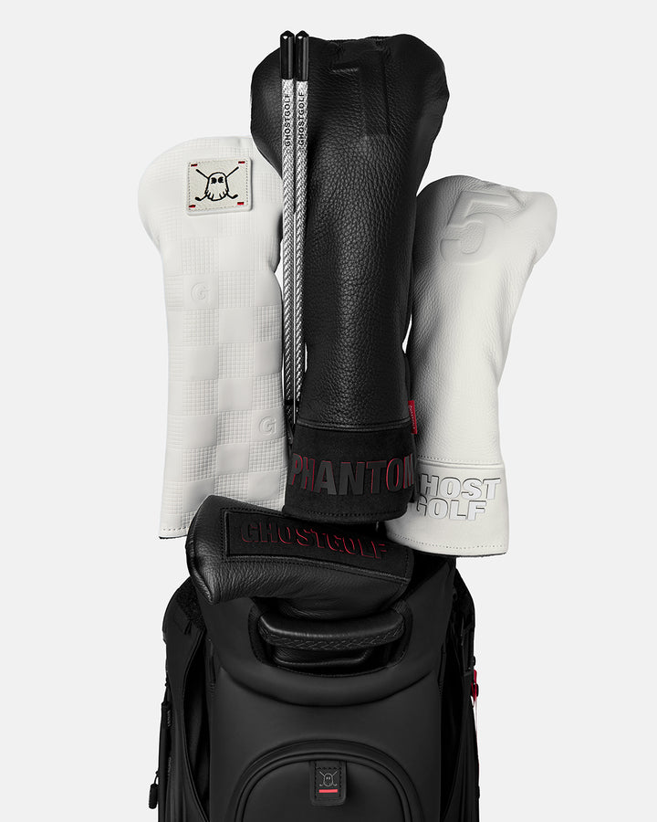 Front view of a Silver Golf Alignment Stick stored in a golf bag beside several golf club head covers
#color_silver