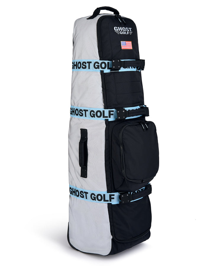 Three-quarter view of the Striker Primary AWOL Travel Bag showcasing Ghost Golf embroidery across the top panel and an embroidered USA flag detail. Angled product image highlighting the bag’s premium construction, travel-ready design, patriotic accents, and signature Ghost Golf craftsmanship. #color_grey
