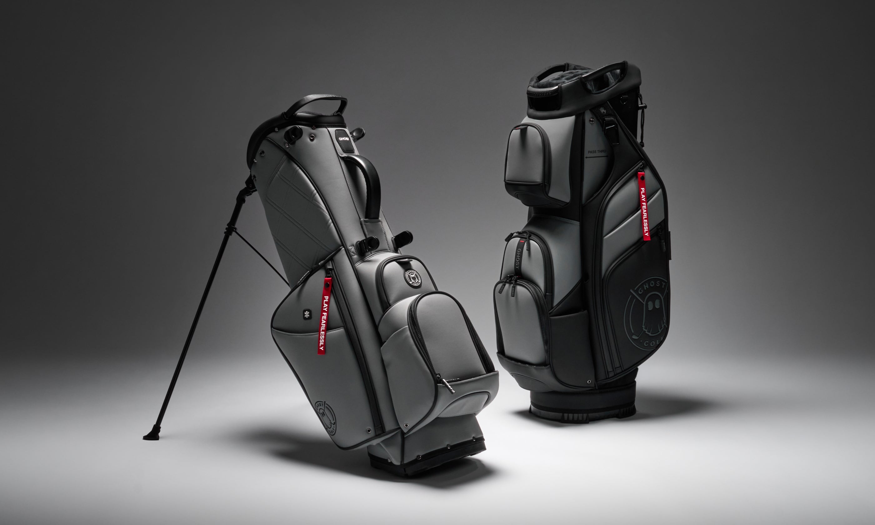 Studio product photo of Ghost Golf bags displayed on elevated platforms, featuring the Anyday Maverick Bag and the GT-14 Kovert Ops Cart Bag.