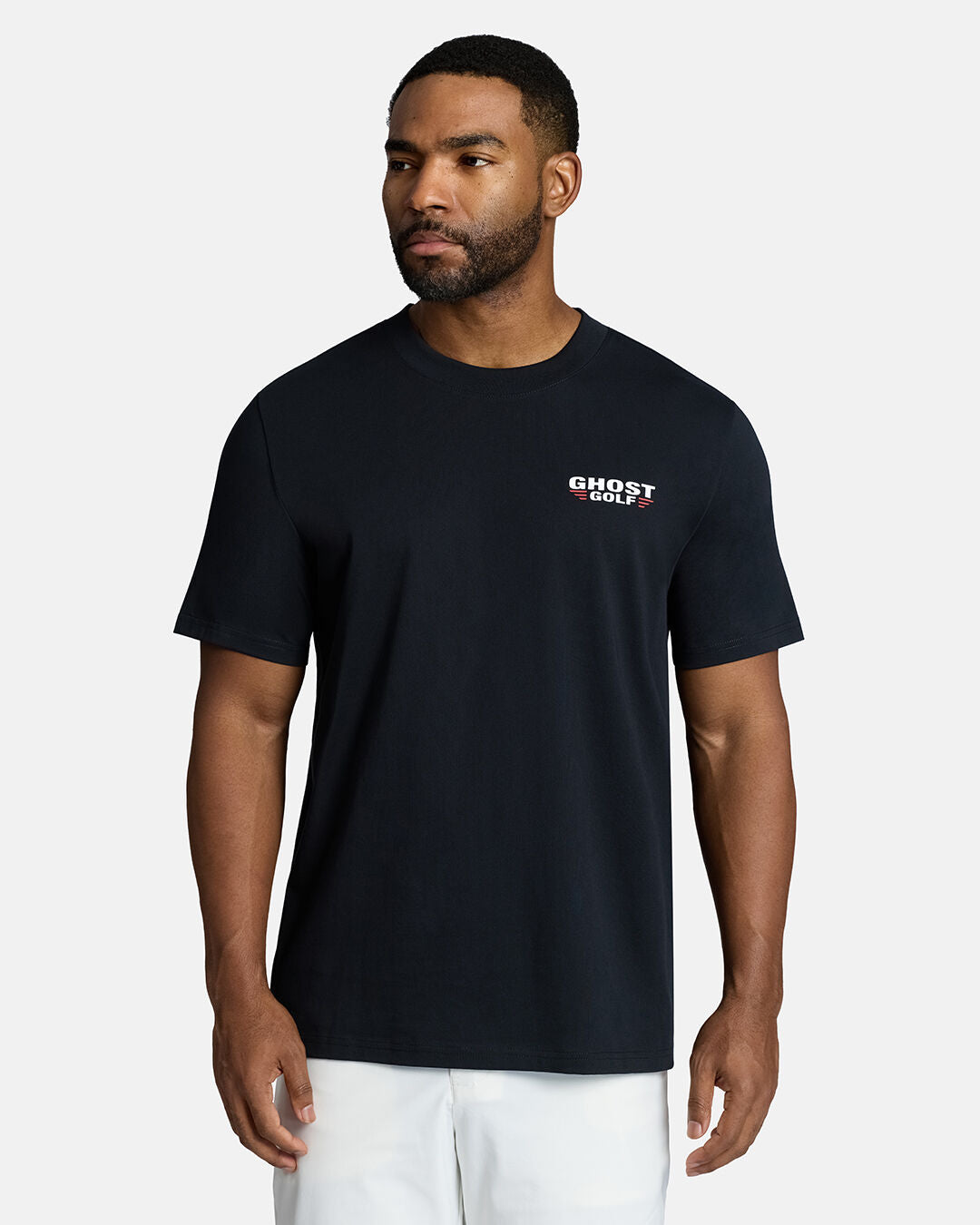 Top Front Body Shot of Black Male Model Wearing Black Flight Tee with white shorts. Ghost Golf Hit on the left front chest #color_black