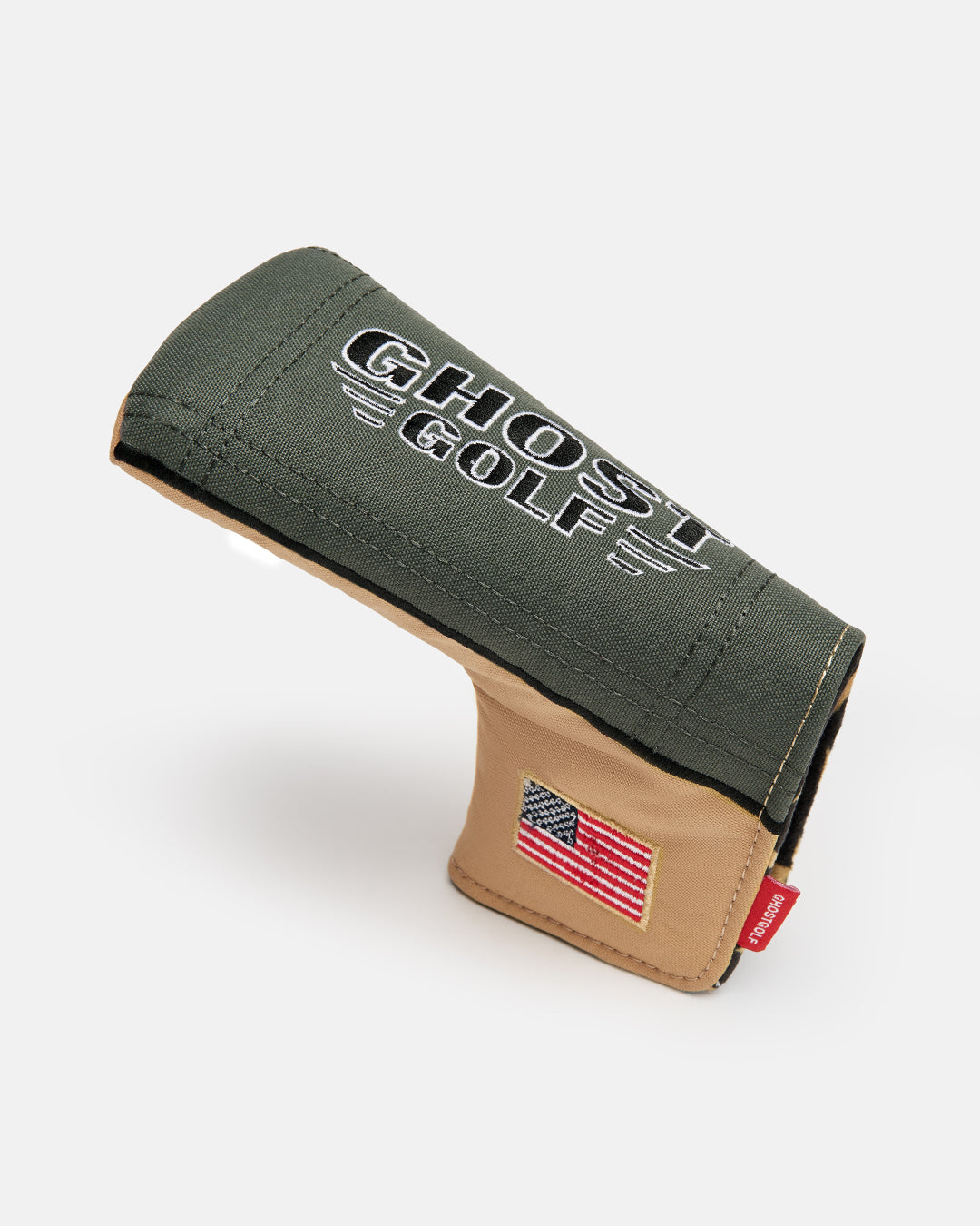 Side product shot of the G-Suit Secondary Blade Putter Cover featuring "USA" embroidery along the lower side panel and the Ghost Golf logo embroidered on the top. Angled profile view highlighting the premium materials, detailed embroidery, patriotic design elements, and signature Ghost Golf craftsmanship.