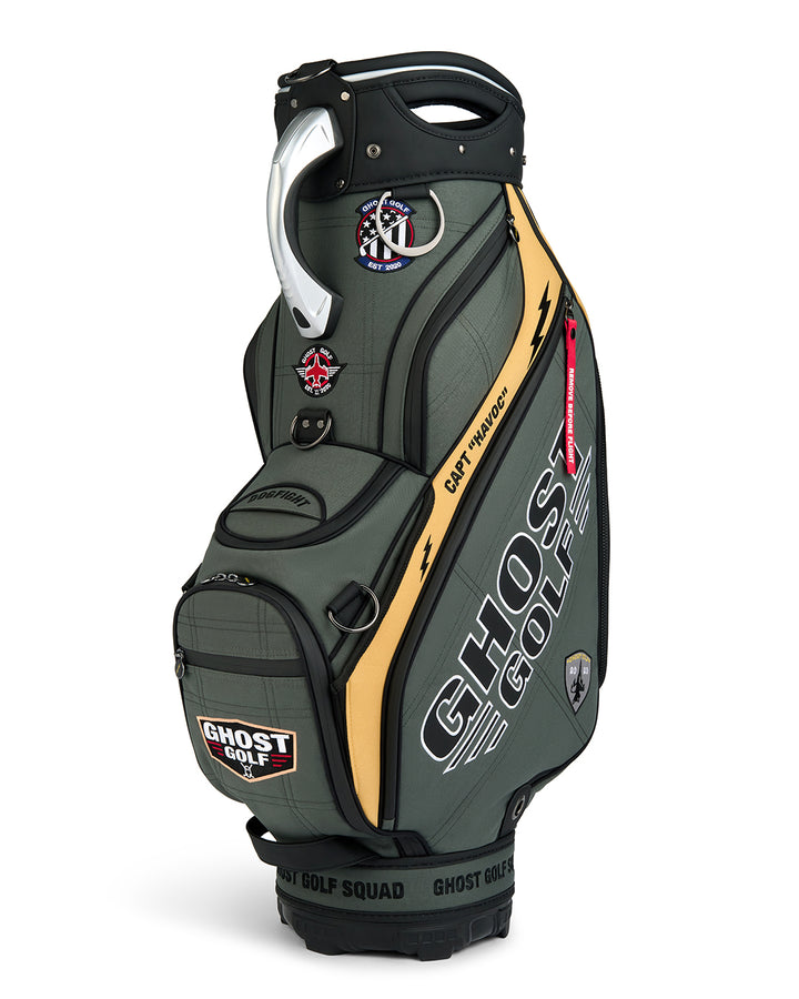 Three-quarter view of the G-Suit Staff Bag showcasing prominent Ghost Golf logo branding and a collection of military aviation-inspired patches. Angled product image highlighting the bag’s premium construction, patriotic design elements, custom embroidered details, and signature Ghost Golf styling.