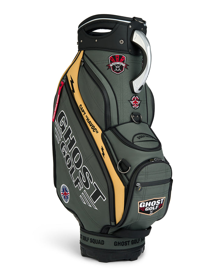 Three-quarter view of the G-Suit Staff Bag showcasing prominent Ghost Golf logo branding and a collection of military aviation-inspired patches. Angled product image highlighting the bag’s premium construction, patriotic design elements, custom embroidered details, and signature Ghost Golf styling.