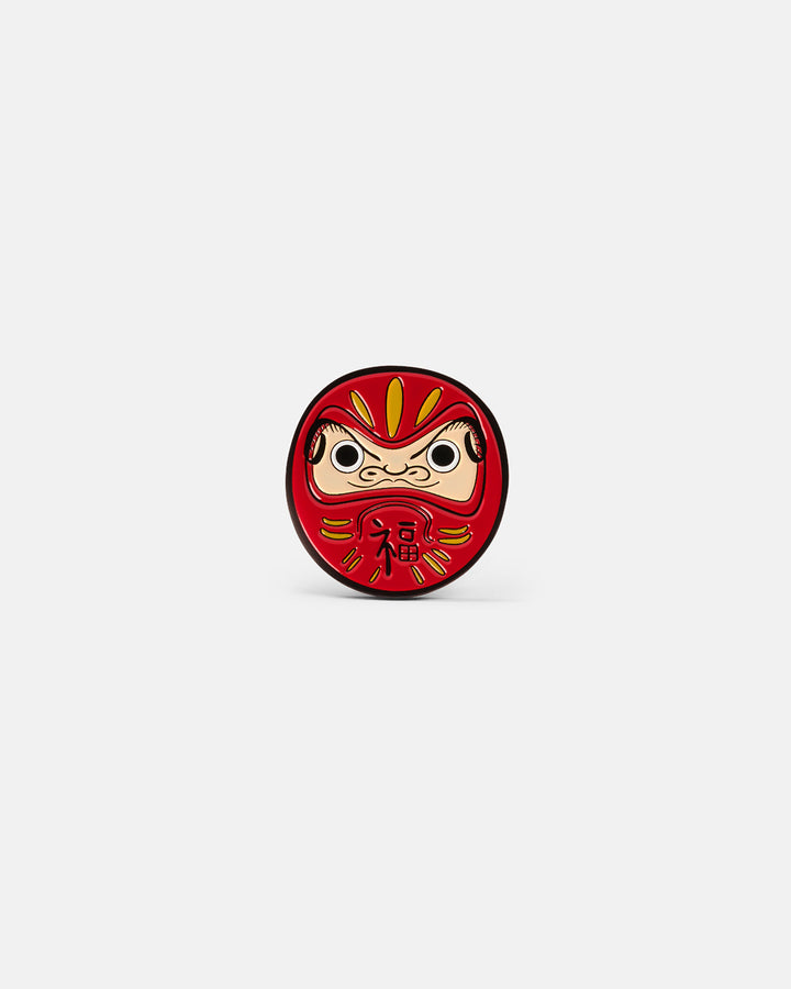 Product photo of a circular ball marker featuring a Daruma doll design.