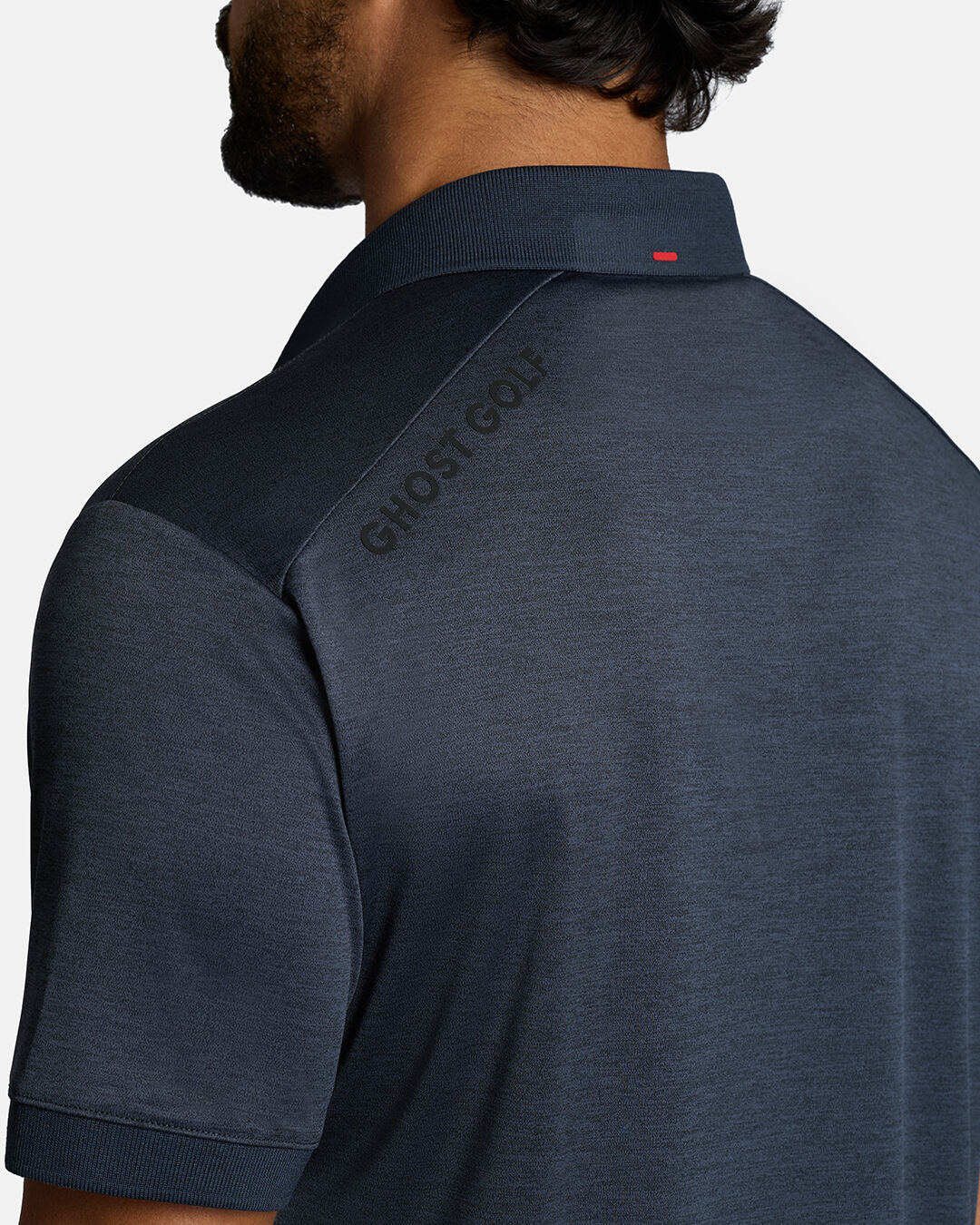 Closeup Back Shoulder Shot of Dakr Navy Marled Core Polo back of the polo showcasing ghost golf hit on left back shoulder #color_dark-navy