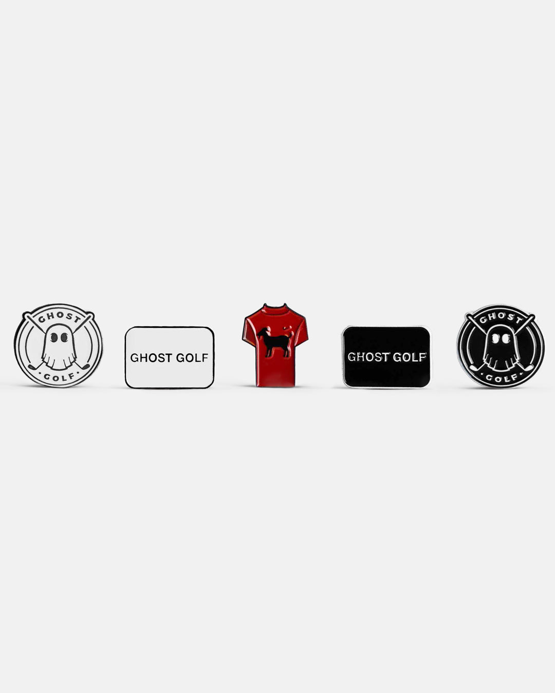 Front product shot of five golf ball markers arranged together. Includes two Emblem logo ball markers (one black, one white), two rectangular ball markers featuring the Ghost Golf logo (one black, one white), and one T-shirt-shaped ball marker with a goat icon. Clean product photography on a plain background.