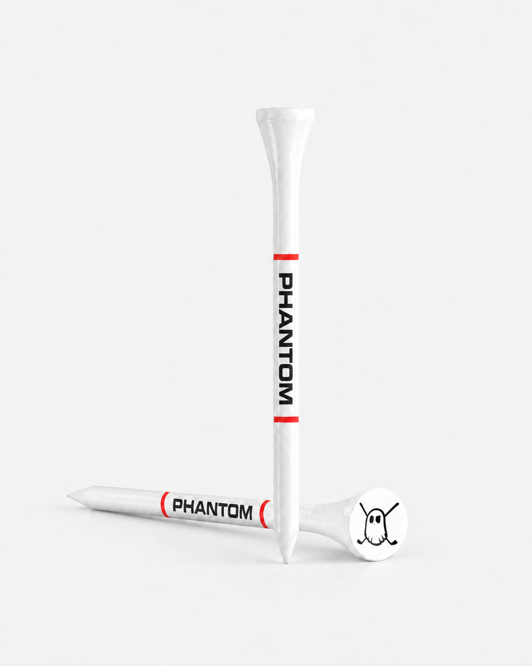 Two white tees with red bands and black 'PHANTOM' text, shown on a clean light gray studio background. One tee is upright and one lies on its side, with a white club head resting on the tee base.