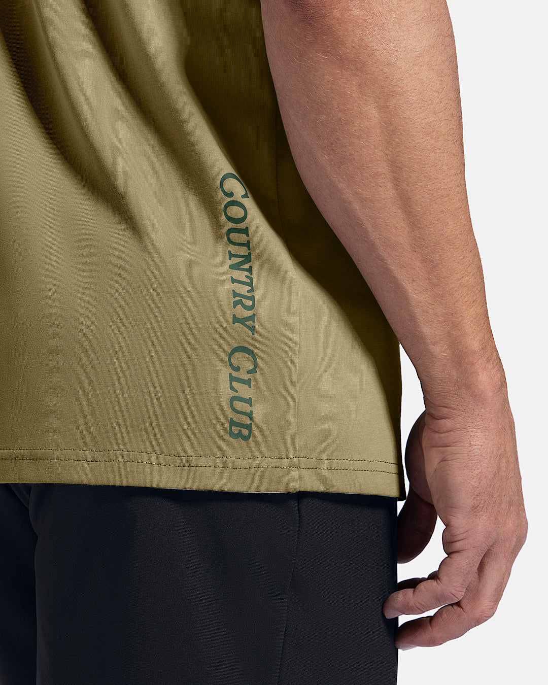 Closeup Side View of Sand Patrons Club Badge Tee on white male model showing text graphic hit #color_sand