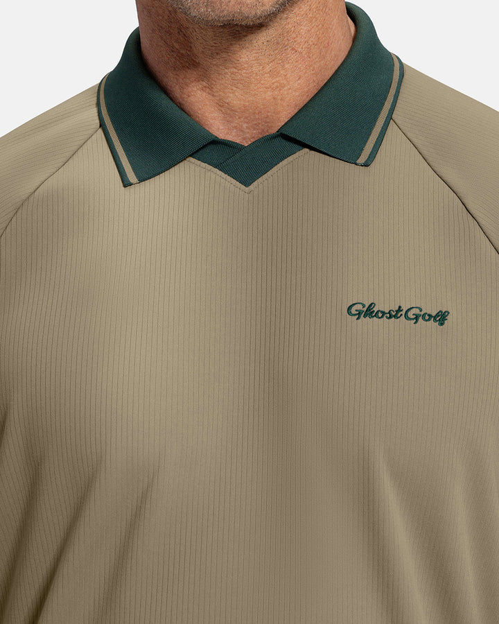 Closeup Front View of Sand Patrons Heritage Polo on white male model showing ghost golf graphic hit #color_sand-wedge