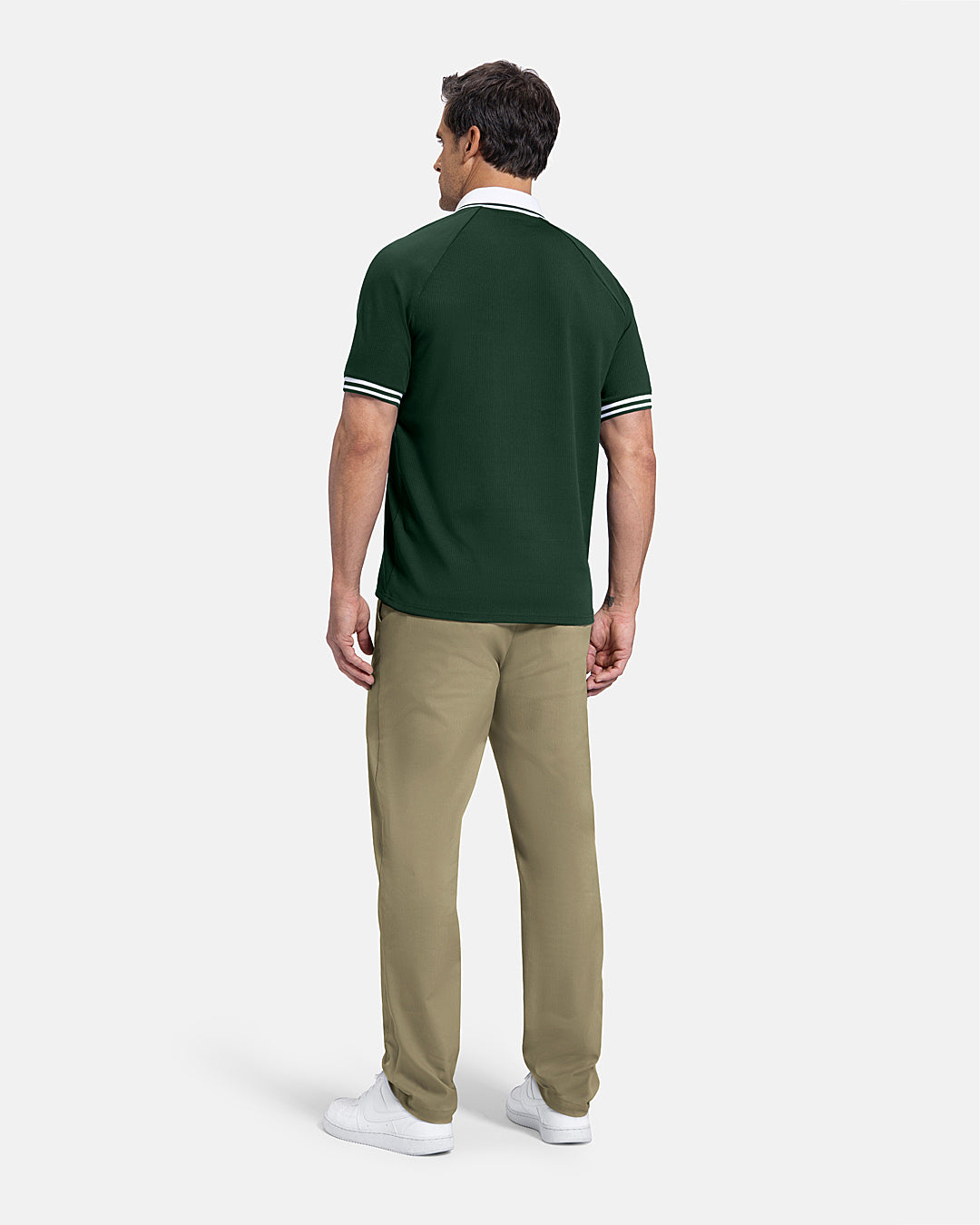 Full Body Back View of Bogey Green Patrons Heritage Polo on white male model wearing beige pants and white shoes #color_bogey-green