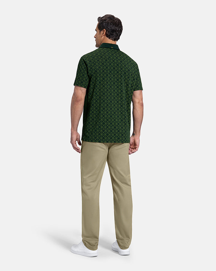 Full Body Back View of Bogey Green Patrons Printed Polo on white male model wearing beige pants and white shoes #color_bogey-green