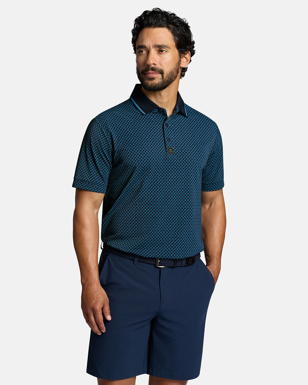 Top Front Body Shot of White Male Model Wearing Dark Navy Qualifier Chase Polo with navy pants and navy belt. Polo is tucked in shorts #color_dark-navy