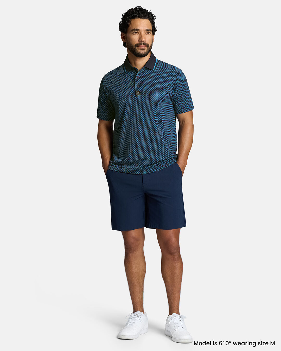 Full Front Body Shot of White Male Model Wearing Dark Navy Qualifier Chase Polo with navy shorts. Polo is untucked #color_dark-navy