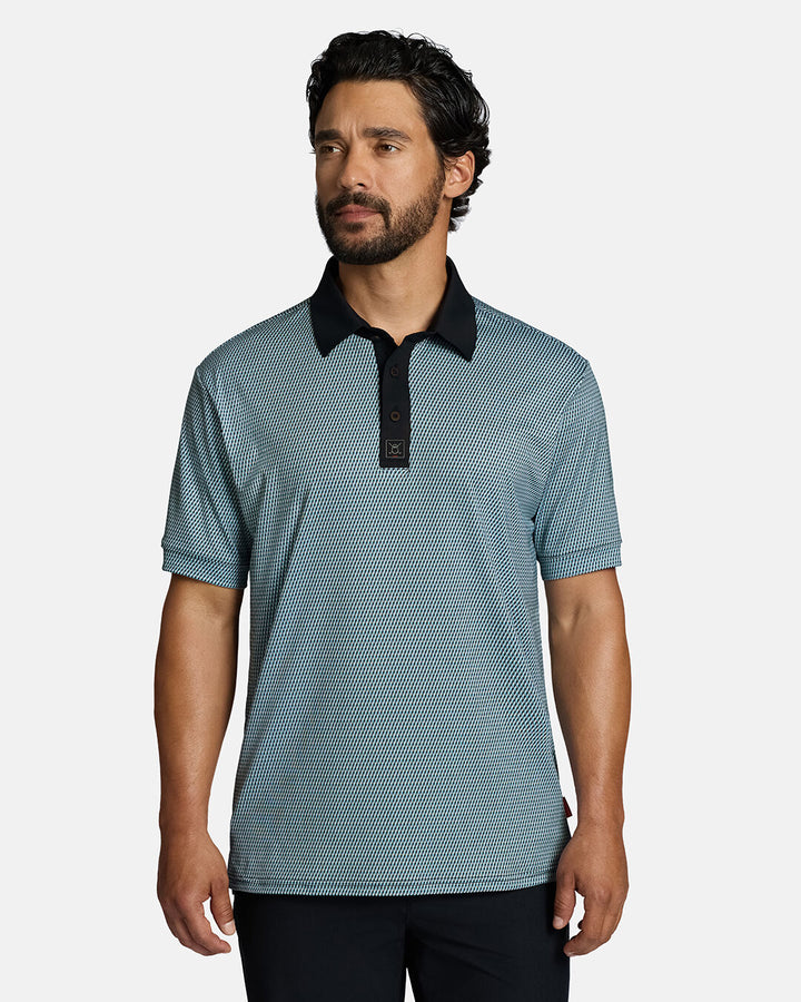 Top Body Front Shot of White Male Model Wearing Blue Qualifier Diamond Polo with black pants. Polo is untucked. #color_blue