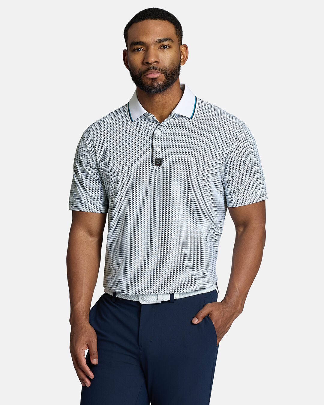 Top Body Front Shot of Black Male Model Wearing White Qualifier Flag Polo with navy pants and white belt with hand in pocket #color_white