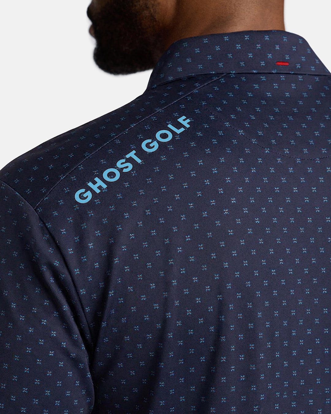 Closeup Back Shoulder Shot of Navy Qualifier Geo Polo back of the polo showcasing ghost golf hit on left back shoulder #color_navy