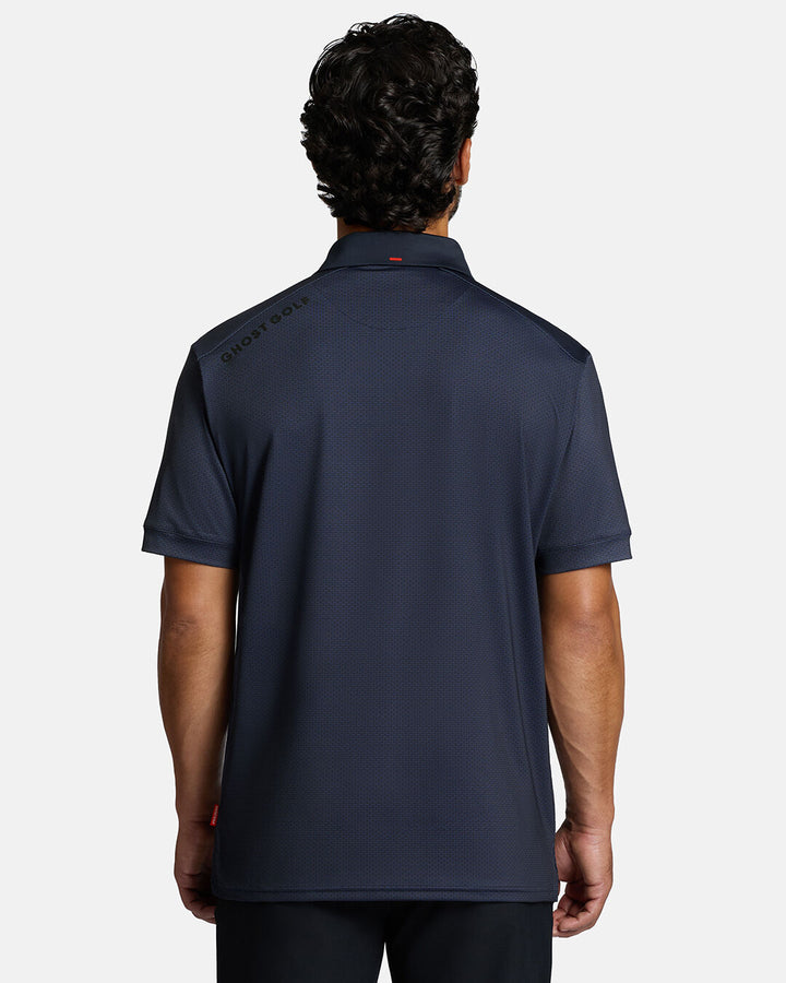Back Shot of White Male Model Wearing Dark Navy Qualifier Grid Polo 
with a ghost golf hit on the left top shoulder #color_dark-navy