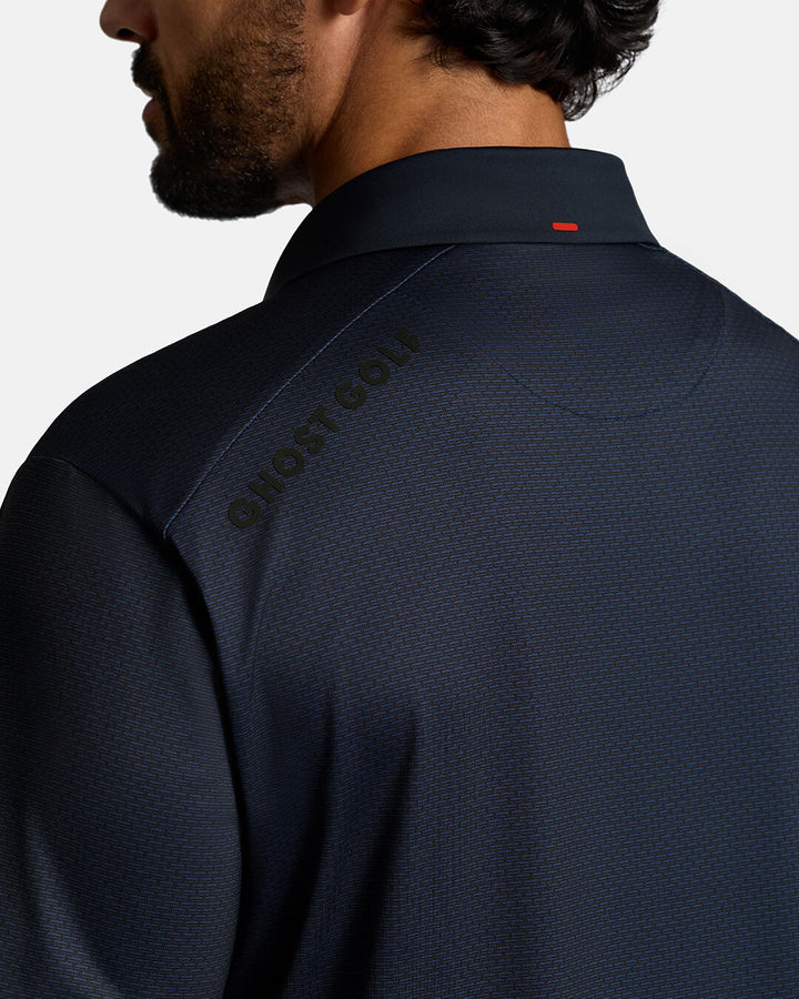 Closeup Back Shoulder Shot of Dark Navy Qualifier Grid Polo back of the polo showcasing ghost golf hit on left back shoulder #color_dark-navy