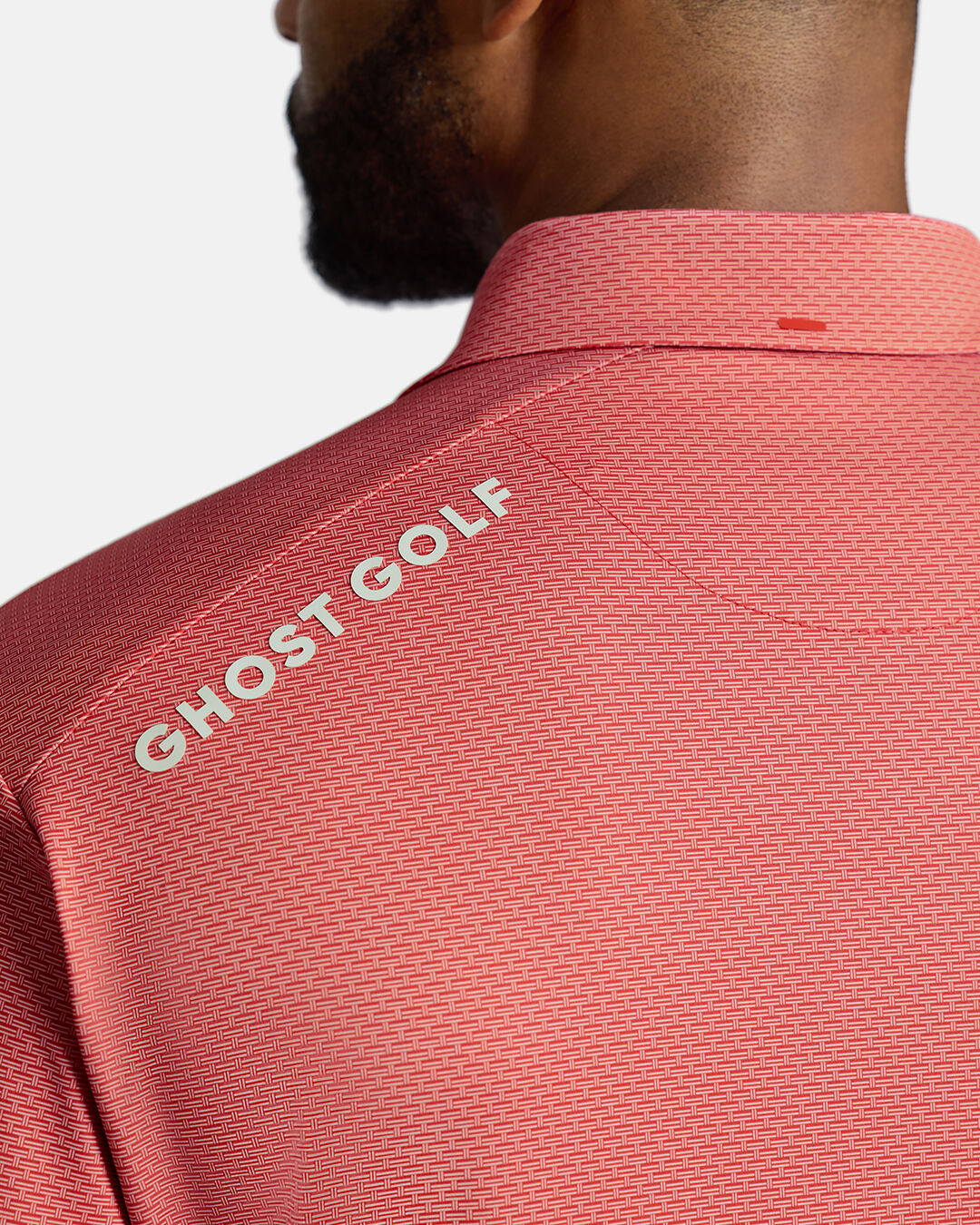 Closeup Back Shoulder Shot of Red Qualifier Grid Polo back of the polo showcasing ghost golf hit on left back shoulder #color_red