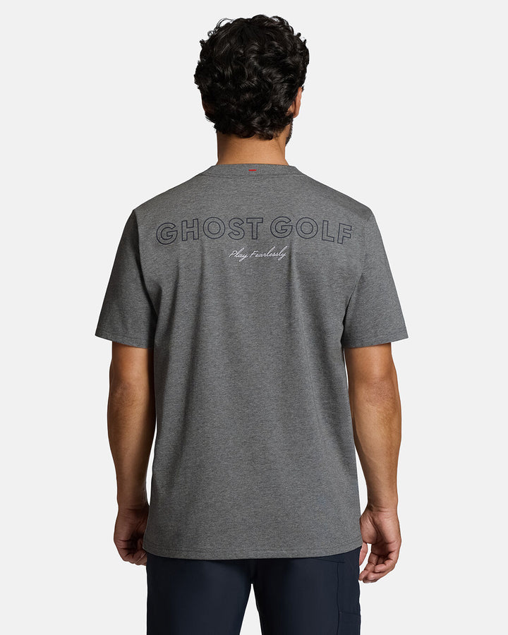 Top Back Body Shot of White Male Model Wearing Grey Qualifier Player Tee show casing typographic design on the back. Model is wearing navy pants #color_heather-grey