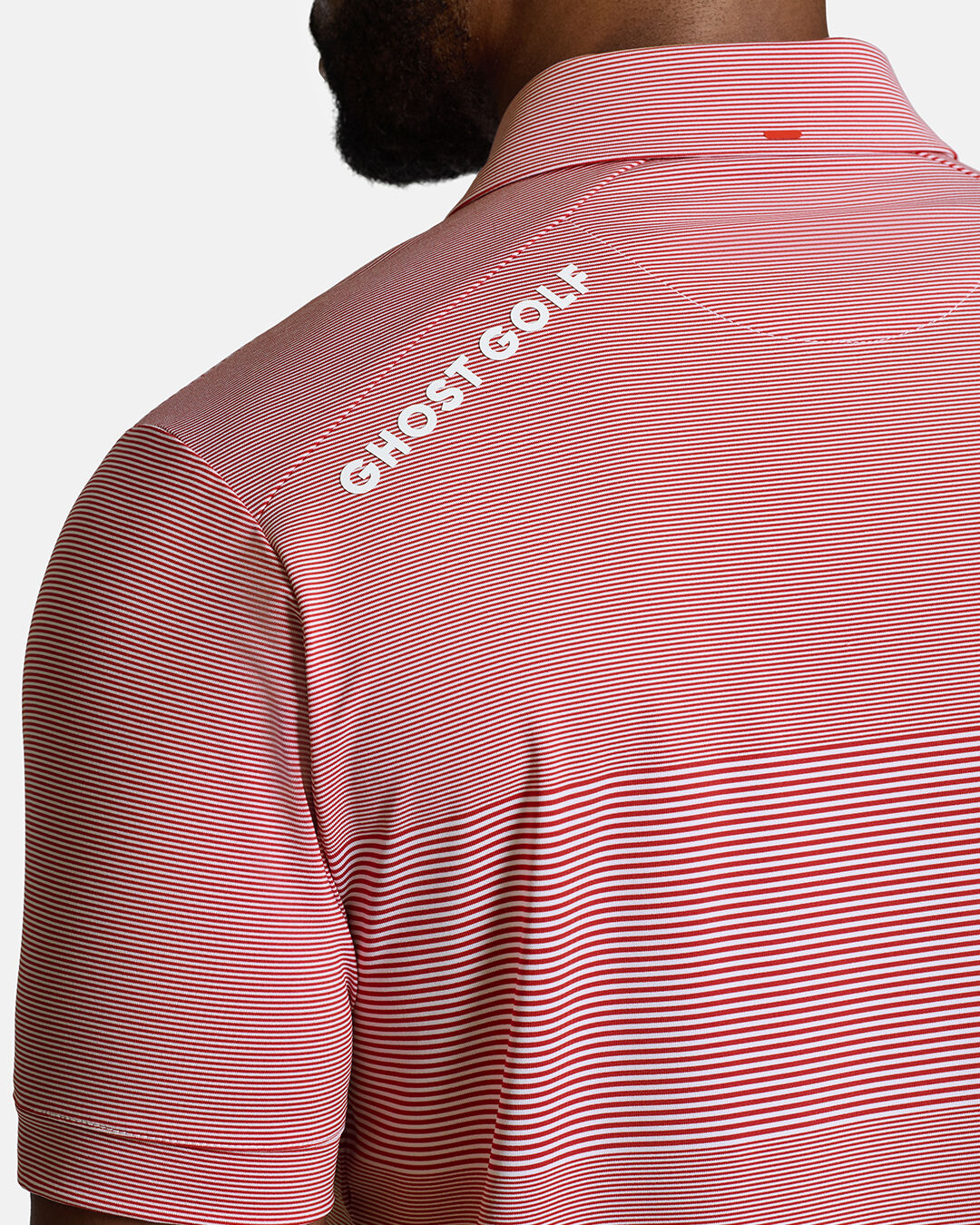 Closeup Back Shoulder Shot of Red Qualifier Stripe Polo back of the polo showcasing ghost golf hit on left back shoulder #color_red