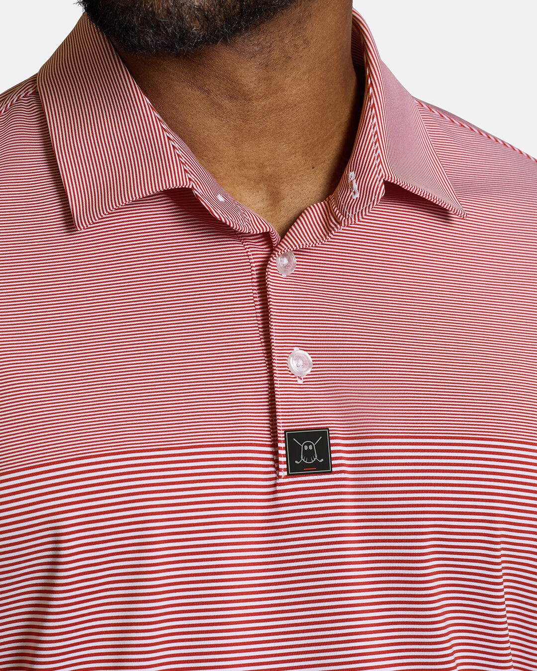 Closeup Front Shot of Red Qualifier Stripe Polo showcasing buttons of polo and ghost golf icon #color_red
