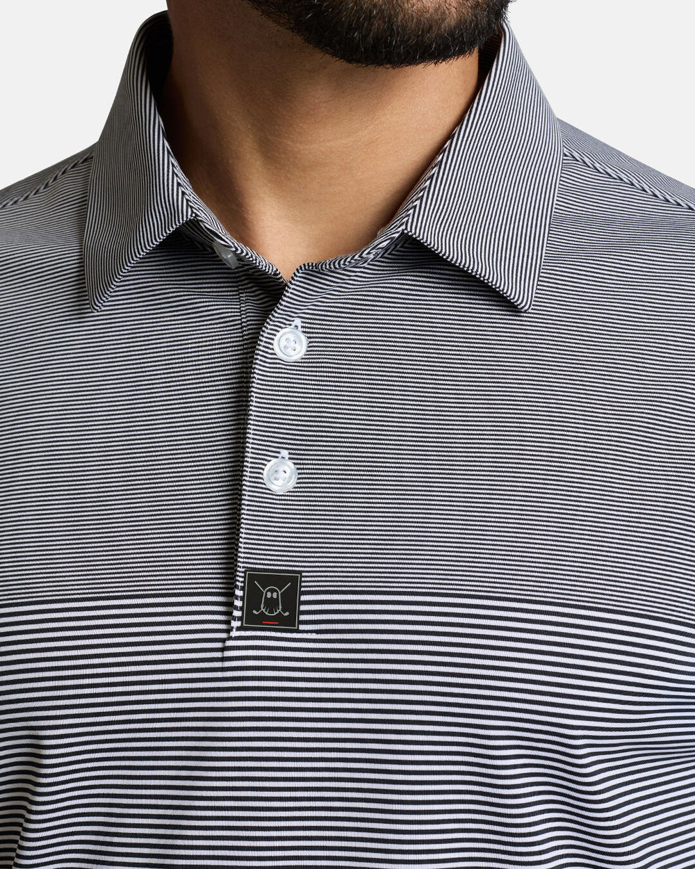 Closeup Front Shot of White Qualifier Stripe Polo showcasing buttons of polo and ghost golf icon #color_dark-navy