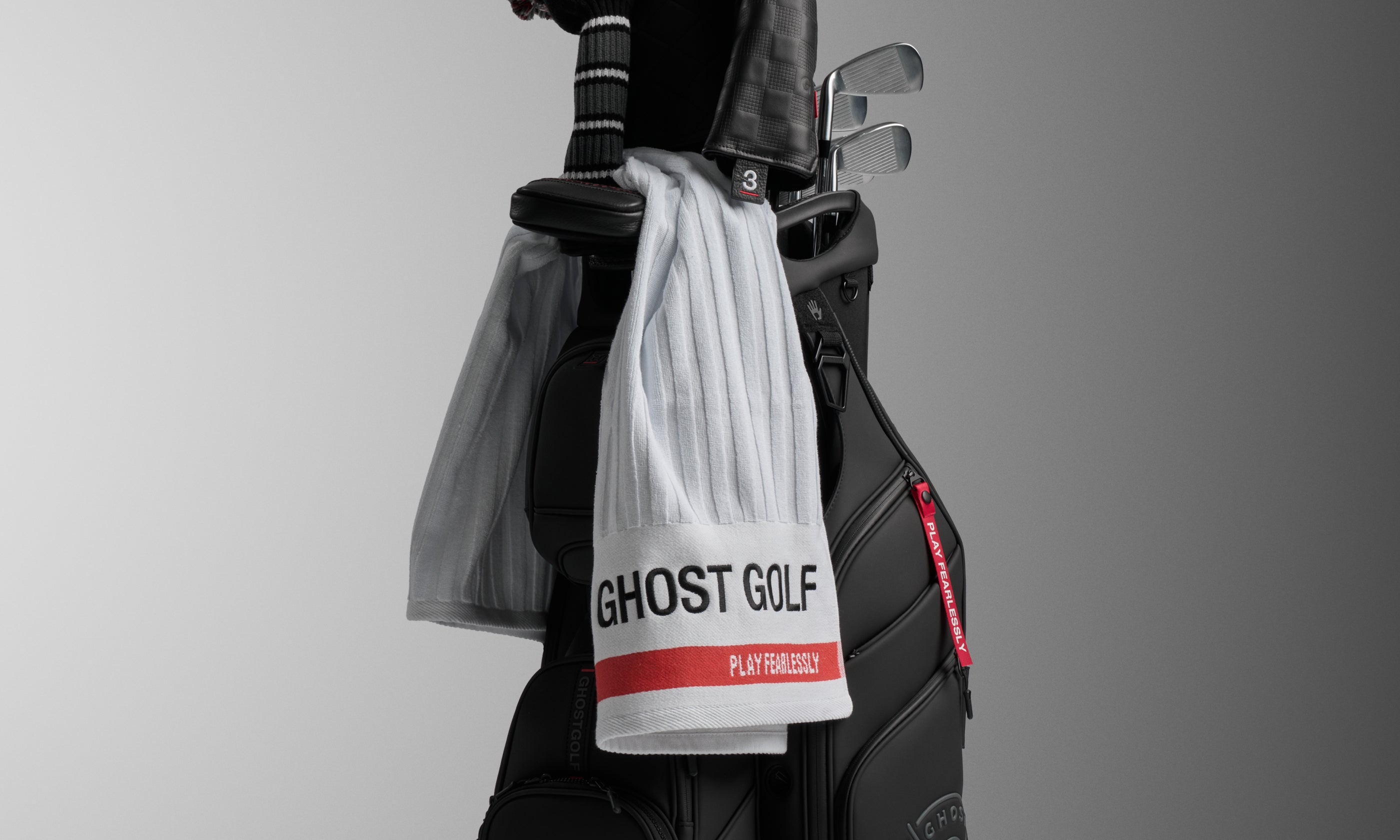 Studio Shot of White Ghost Golf Towel haning over a Cart Bag