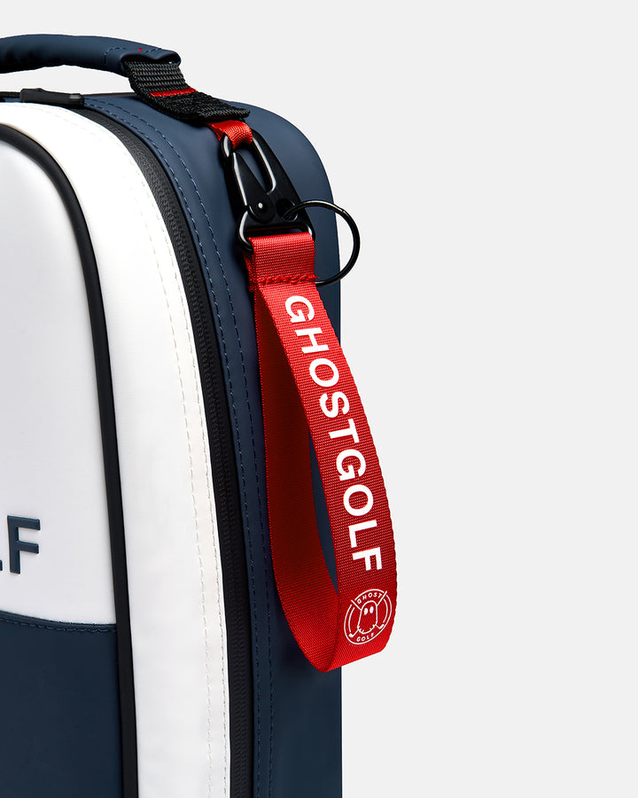 Closeup shot of Valor Ghost Golf Shoe Bag showcasing carabiner and red tag loop with ghost golf logo branding. #color_valor