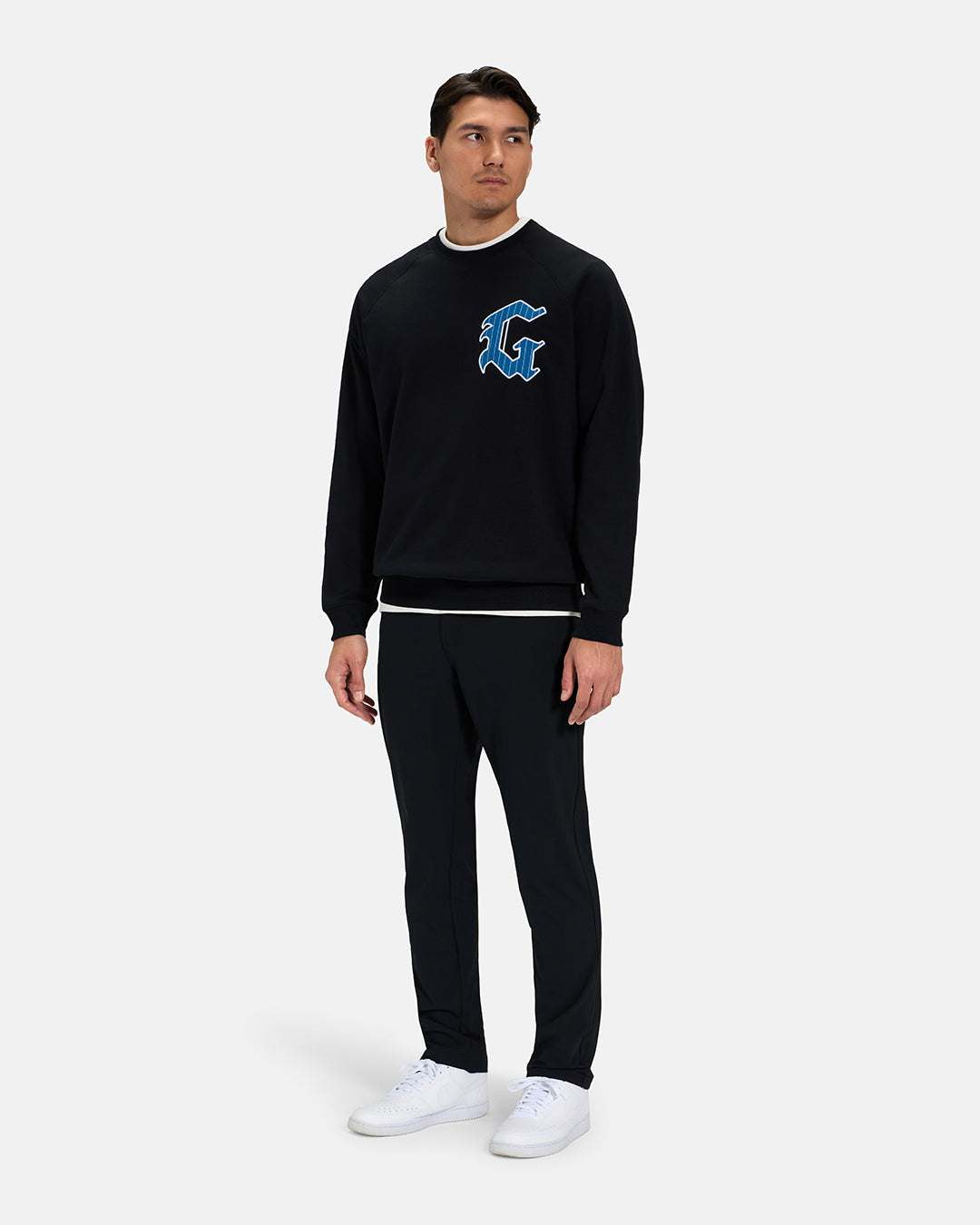 Full Body View of Black Spectator Raglan Sweatshirt on Asian Male Model wearing white tee black pants and white shoes #color_black