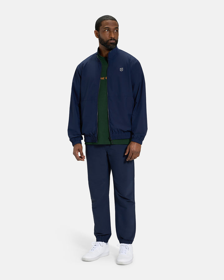 Full Body View of Plaid Dark Navy Spectator Reversible Jacket on Black Male Model wearing forest green tee navy joggers and white shoes #color_plaid-navy