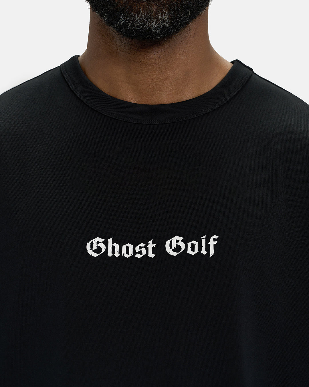 Front Closeup View of Black Spectator Tee on Black Male Model with Ghost Golf #color_black