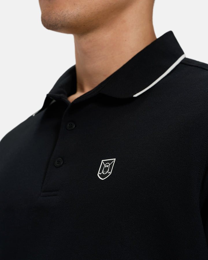 Front Closeup View of Black Spectator Tipped Colllar Polo on Asian Male Model with Ghost Icon Crest #color_black