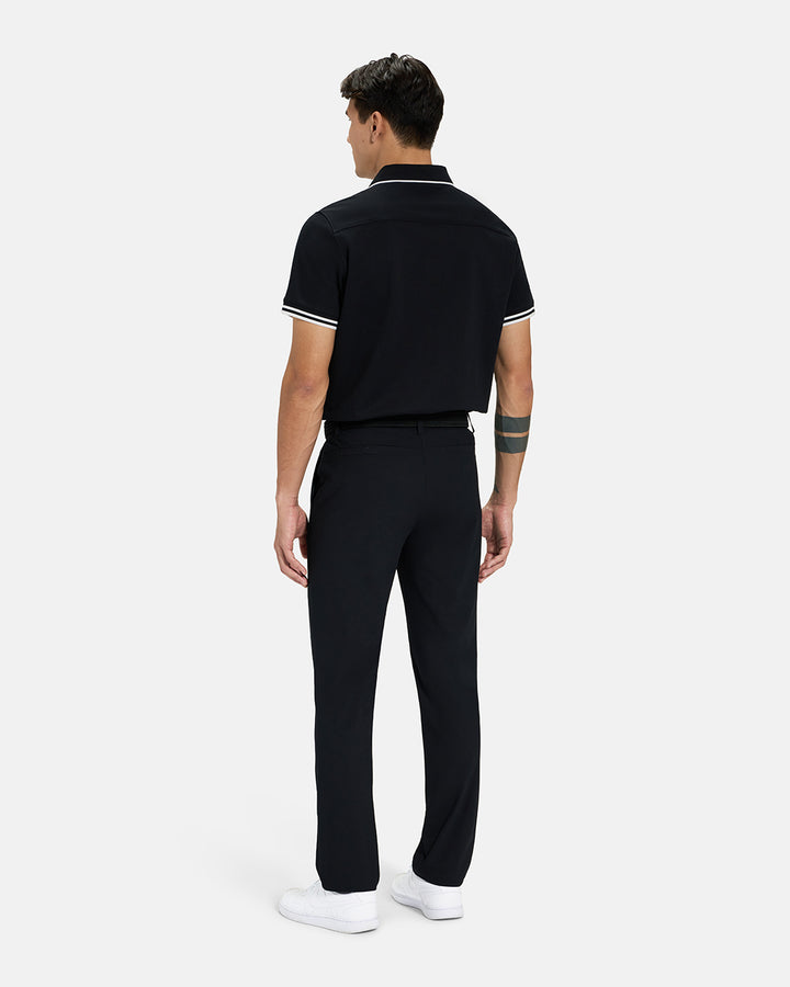 Full Body Back View of Black Spectator Tipped Collar Polo on Asian Male Model wearing black pants black belt and white shoes #color_black