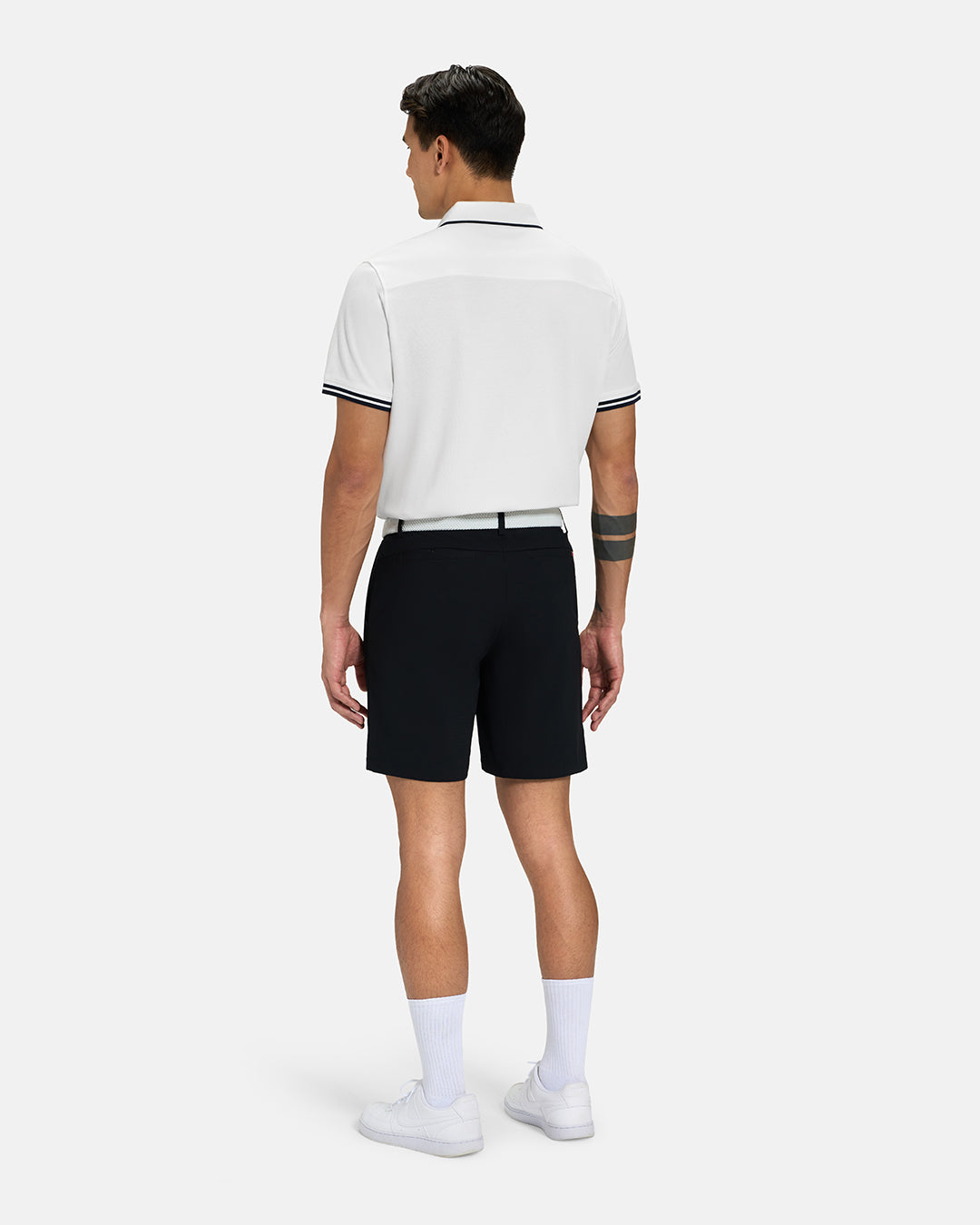 Full Body Back View of White Spectator Tipped Collar Polo on Asian Male Model wearing blackshorts white belt and white shoes #color_white