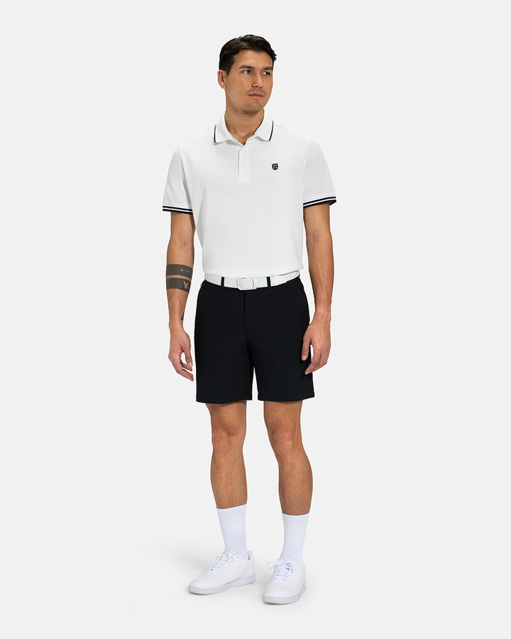 Full Body View of White Spectator Tipped Collar Polo Tucked on Asian Male Model wearing black shorts white belt and white shoes #color_white