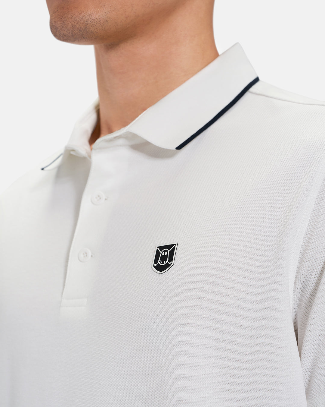 Closeup Front View of White Spectator Tipped Collar Polo on Asian Male model with Ghost Crest Icon #color_white