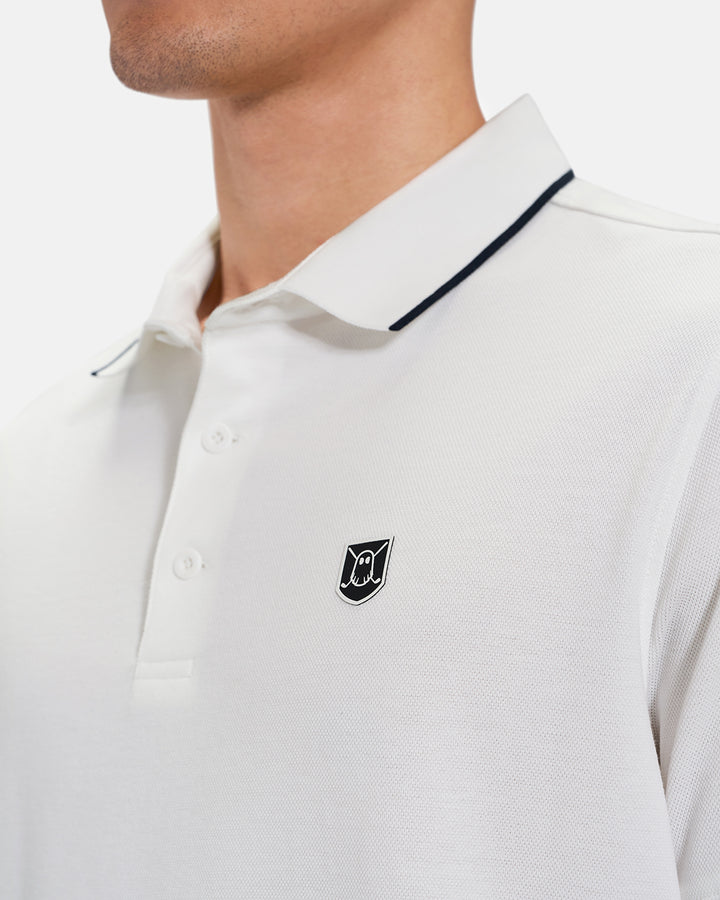 Closeup Front View of White Spectator Tipped Collar Polo on Asian Male model with Ghost Crest Icon #color_white