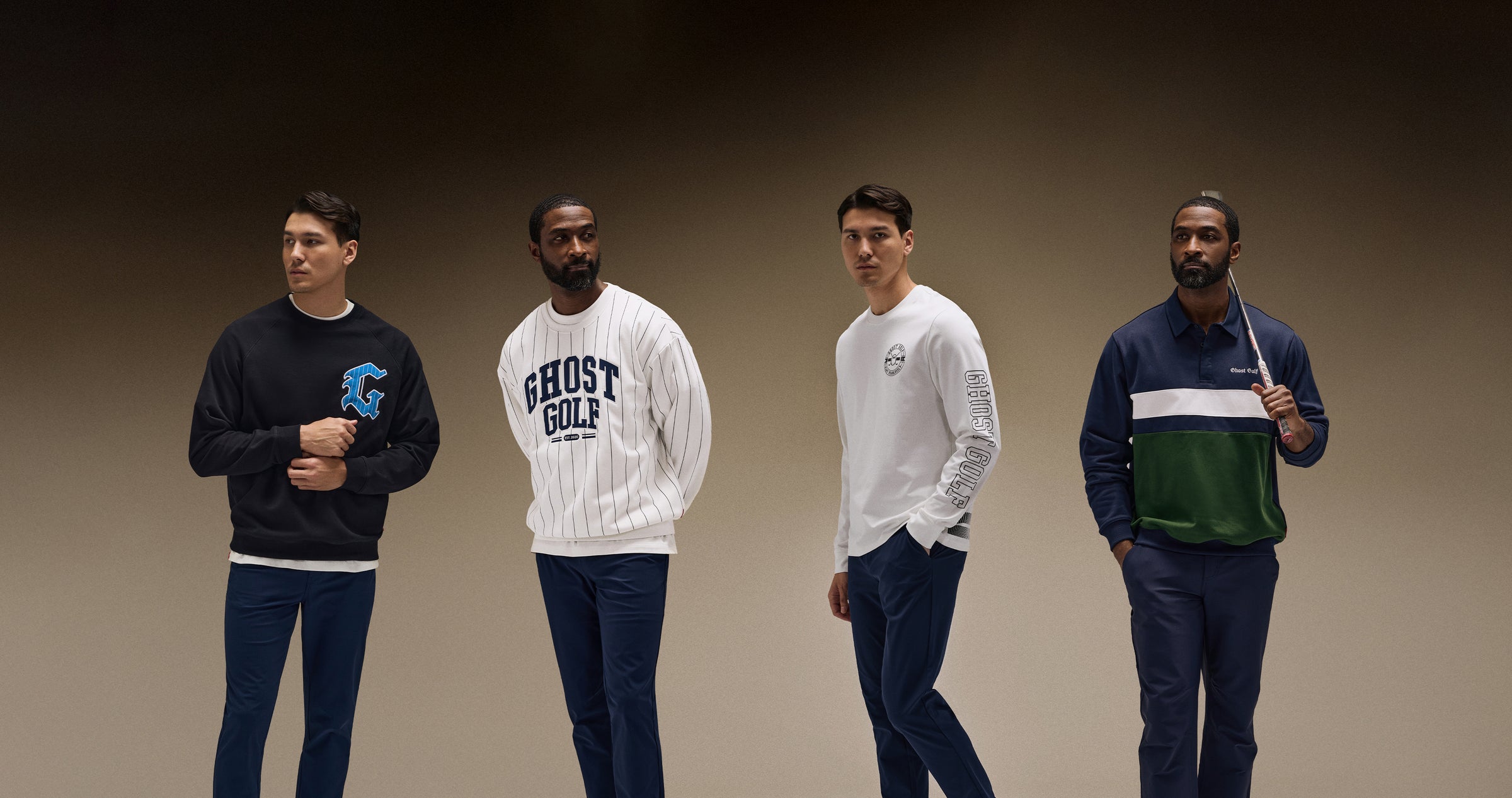 Asian and Black male models photographed in a brown studio setting. Asian models wear a white long-sleeve tee and a black sweatshirt featuring the letter G, paired with navy pants. Black models wear a white Ghost Golf sweatshirt and a navy long-sleeve polo, also paired with navy pants.