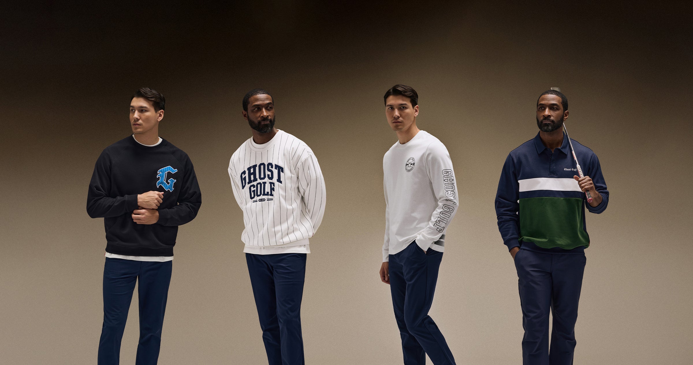 Asian and Black male models photographed in a brown studio setting. Asian models wear a white long-sleeve tee and a black sweatshirt featuring the letter G, paired with navy pants. Black models wear a white Ghost Golf sweatshirt and a navy long-sleeve polo, also paired with navy pants.