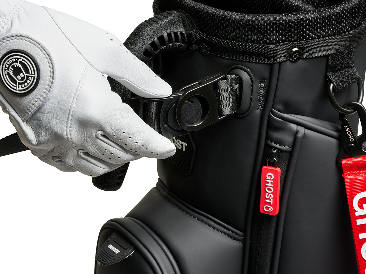 Close-up of a golf bag with a white glove on a white background 