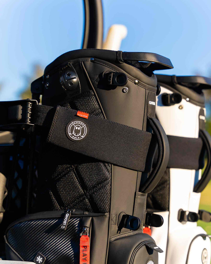 Golf Bag shown with Black Cart Strap Sleeve on a Golf Cart.
